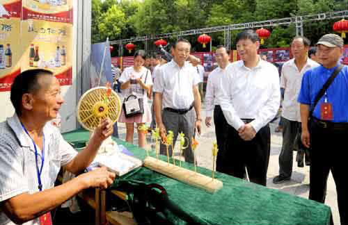 余學友察看“中國農(nóng)加工洽談會”非物質(zhì)文化遺產(chǎn)展展區(qū)